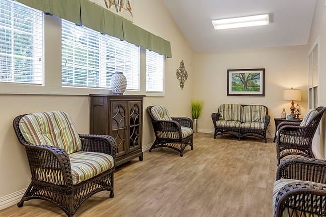 A cozy living room with wicker furniture and natural light.
