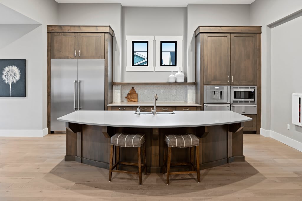 A modern kitchen with wooden cabinetry, an island counter, and stainless steel appliances.