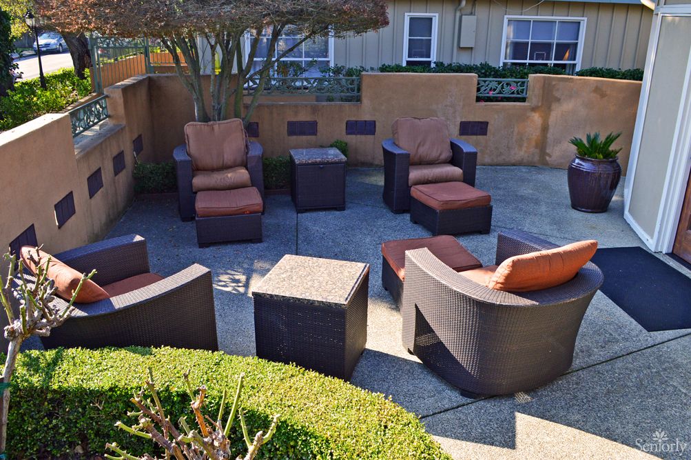 A cozy outdoor seating area with cushioned chairs arranged around a patio.