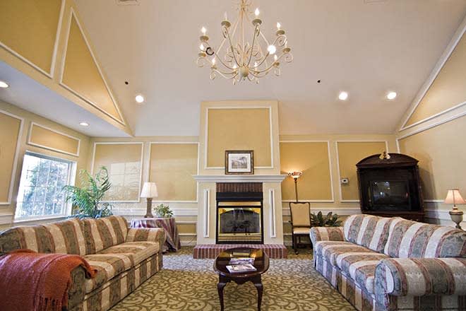 A cozy living room with elegant furnishings and a warm fireplace.