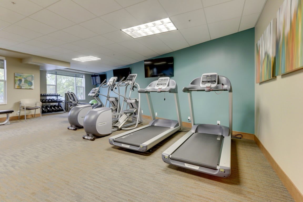 A modern gym with treadmills and other exercise equipment.