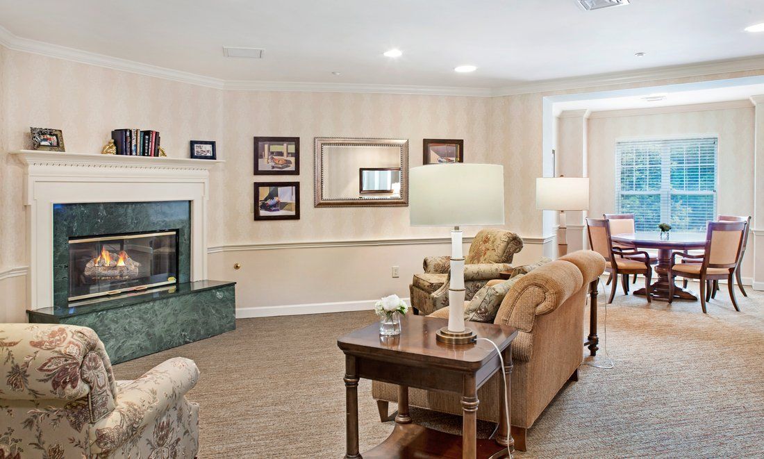 A cozy living room featuring comfortable sofas, a fireplace, and elegant decor.