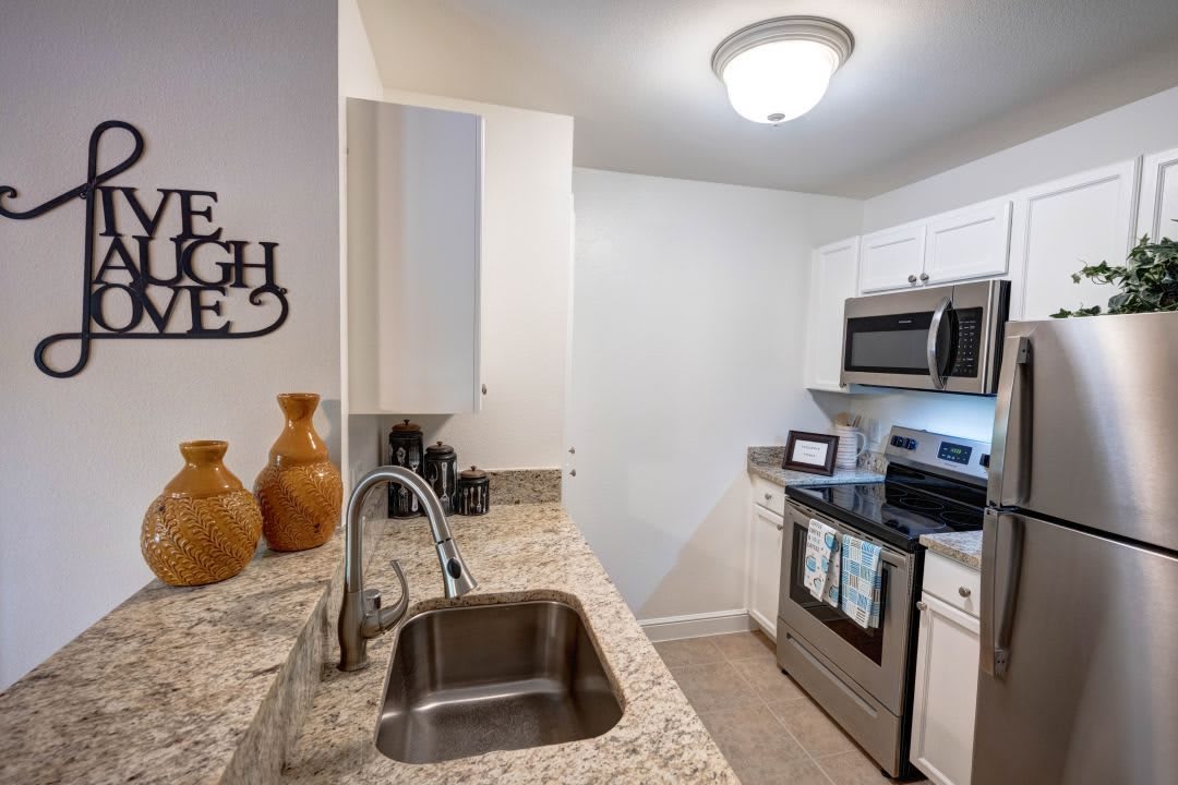 A modern kitchen featuring stainless steel appliances and granite countertops.