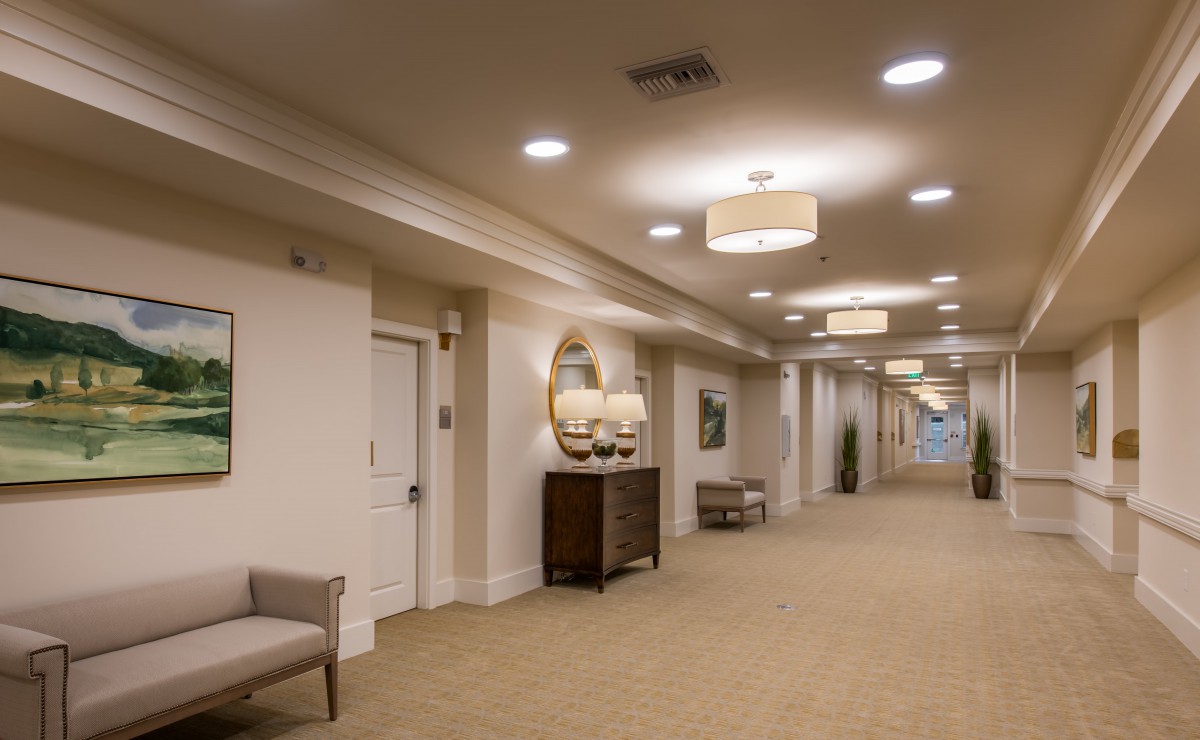 A well-lit hallway with elegant decor and comfortable seating.