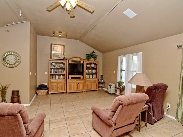 A cozy living room with an entertainment center and comfortable seating.