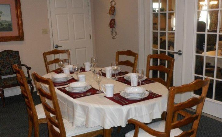 A dining table set for a meal with dishes, cups, and cutlery.