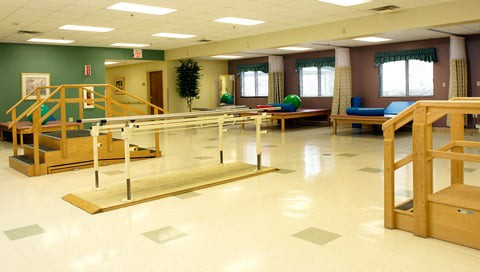 A rehabilitation center with exercise equipment and therapy areas.