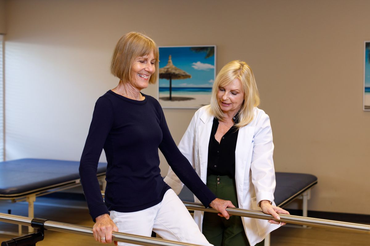 A patient receives guidance from a healthcare professional during a physical therapy session.