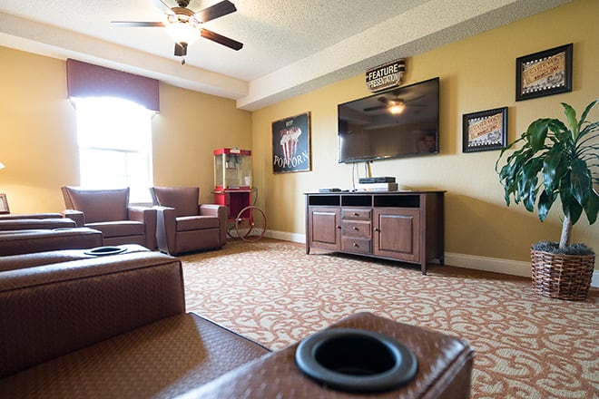 A cozy home theater setup with comfortable seating and a large television.
