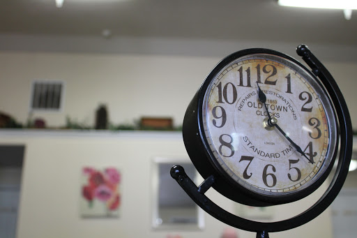 A classic wall clock displaying the time in a cozy interior setting.