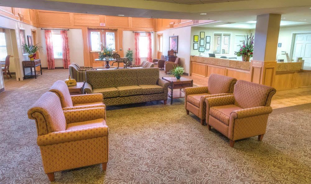 A cozy lobby with comfortable seating arrangements and a reception desk.