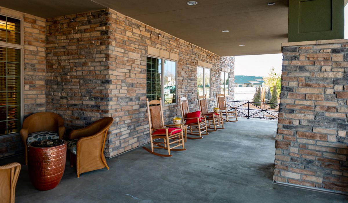 A cozy porch with rocking chairs and a scenic view.