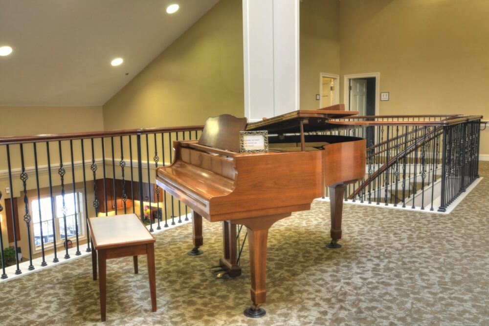 A grand piano with a bench in an elegant indoor setting.