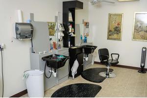A modern hair salon interior with styling stations and chairs.