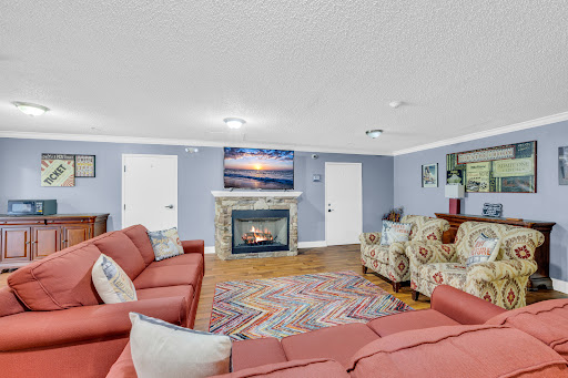 A cozy living room featuring a fireplace, comfortable seating, and a relaxing atmosphere.
