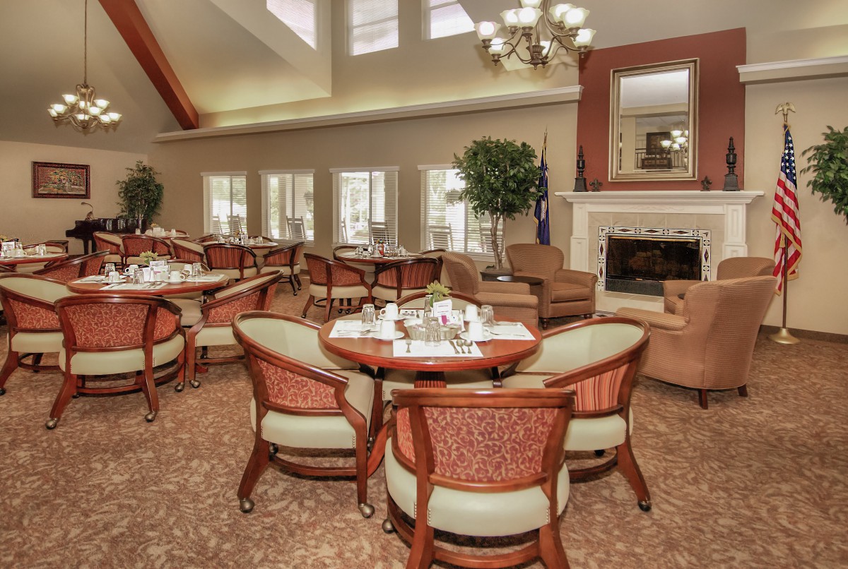A cozy dining area with elegant furnishings and a fireplace.