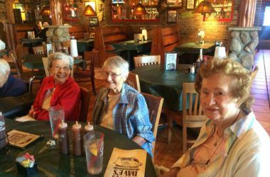 A group of seniors enjoying a meal together at a restaurant.