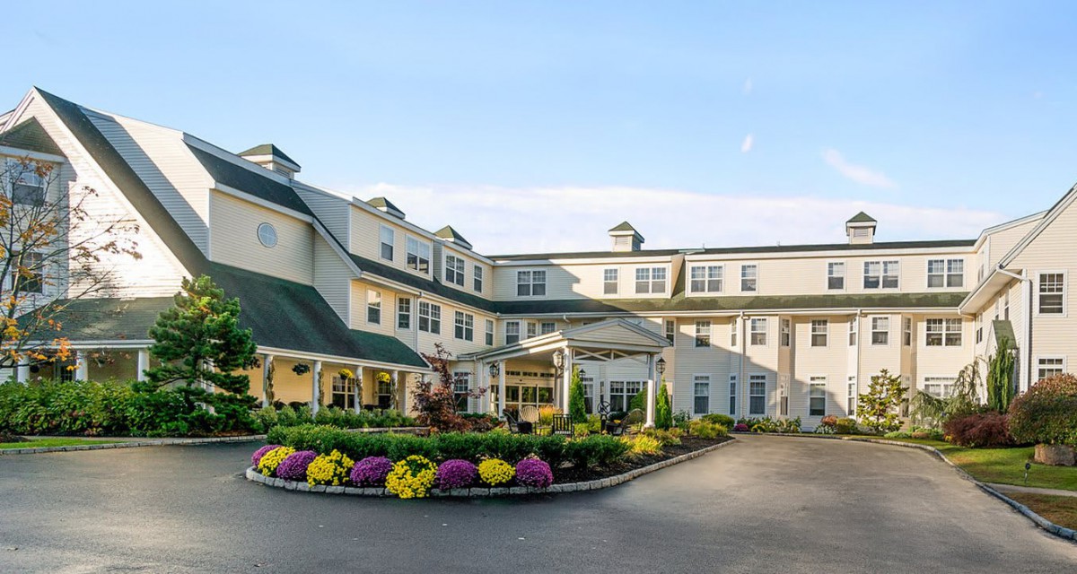 A beautifully landscaped hotel exterior with vibrant flowers and a welcoming entrance.