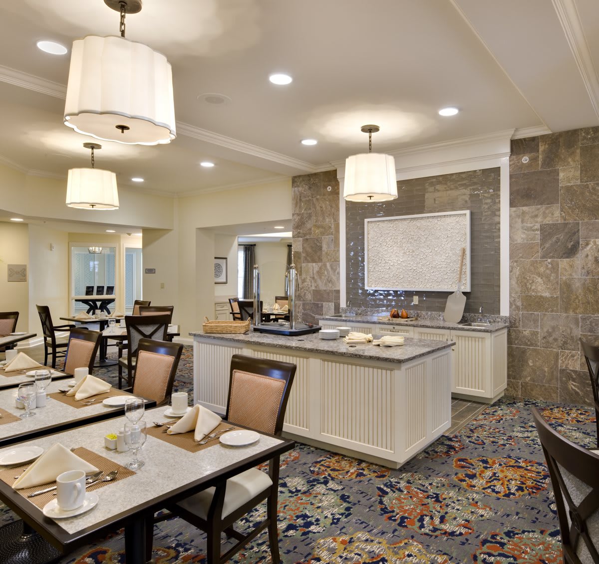 A modern dining room with elegant lighting and contemporary furnishings.