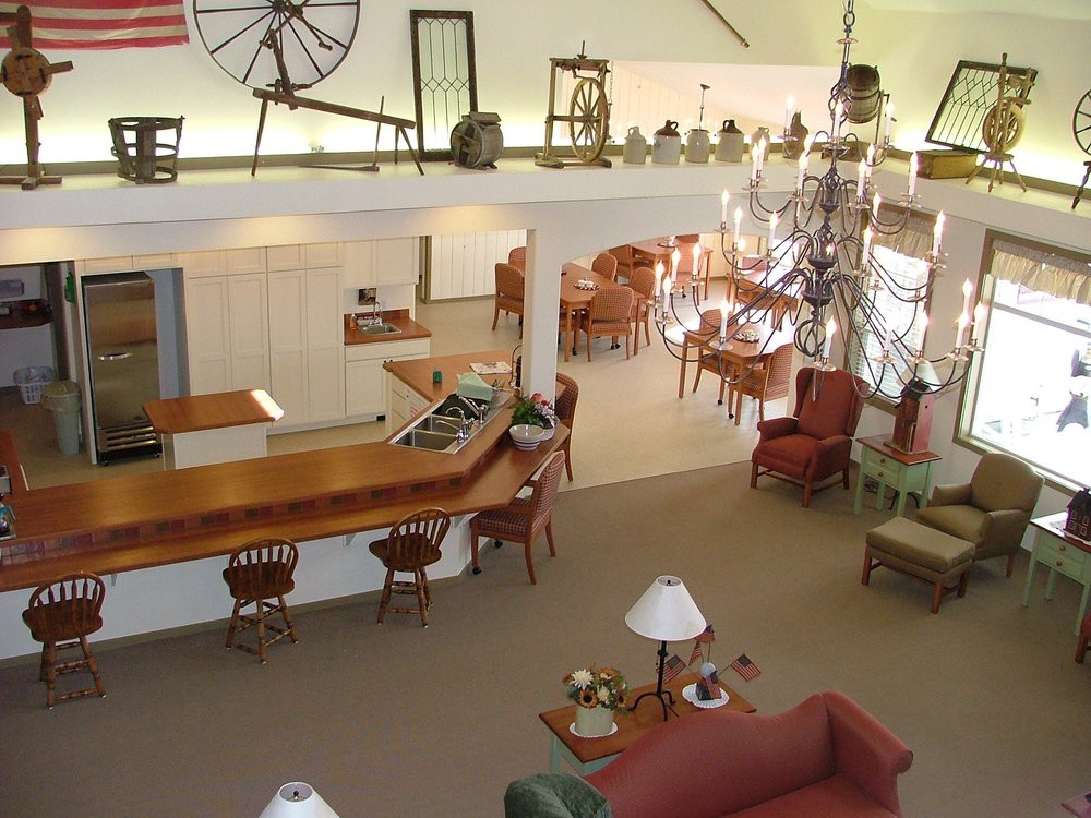A spacious lobby area with various furniture pieces, including chairs and tables, decorated with unique decor and natural lighting.