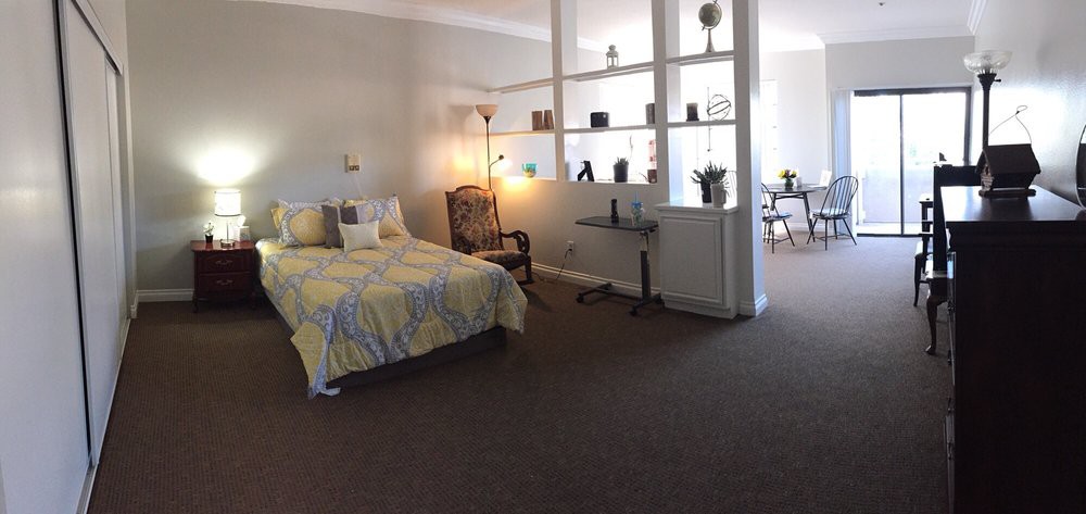 A cozy bedroom with decorative shelving and stylish furniture.