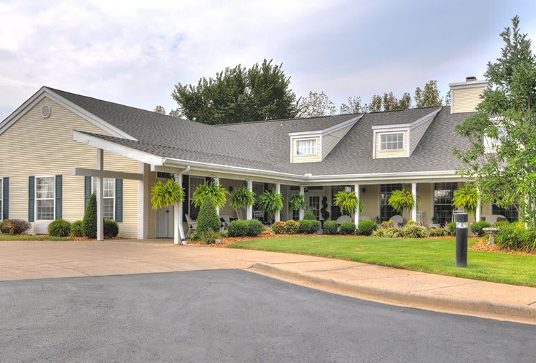 A charming residential house with a driveway and well-maintained garden.