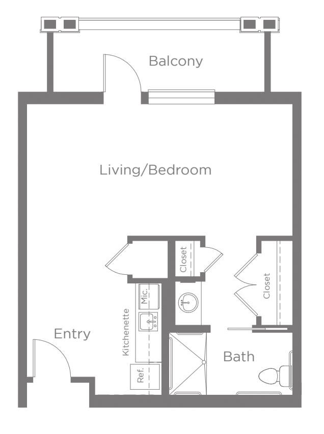 A floor plan of a studio apartment featuring a combined living/bedroom, kitchen area, bathroom, and balcony.