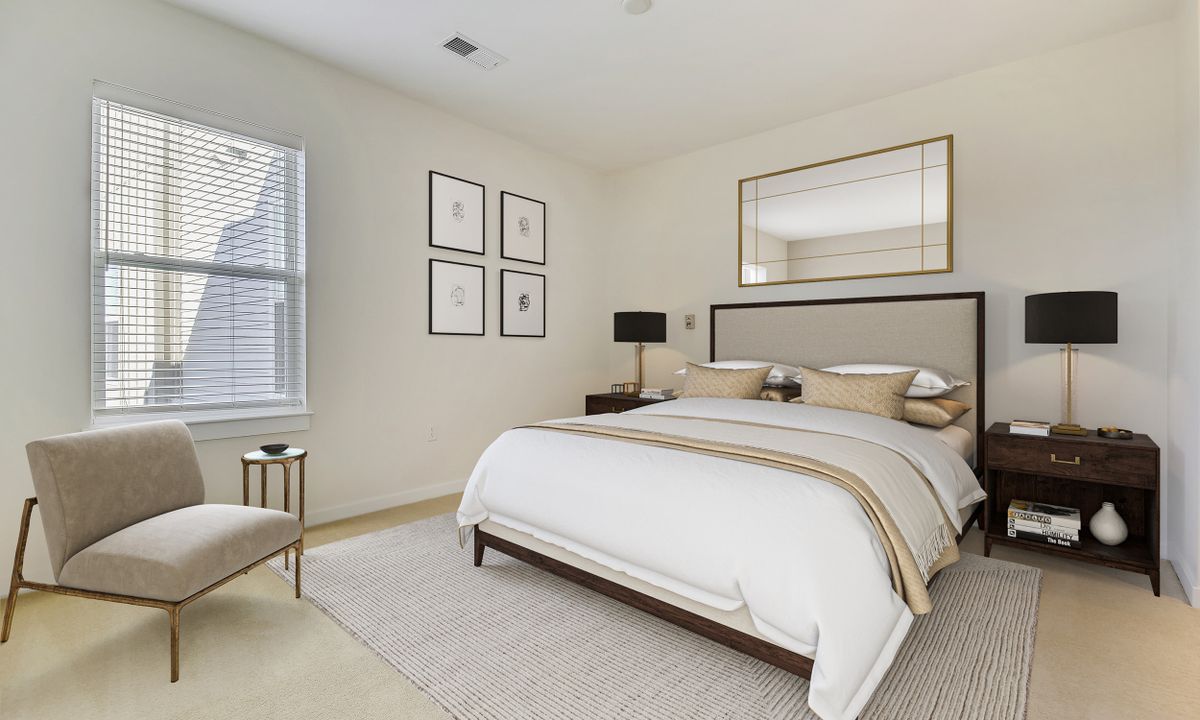 A modern, minimalist bedroom with a large bed, stylish decor, and natural lighting.