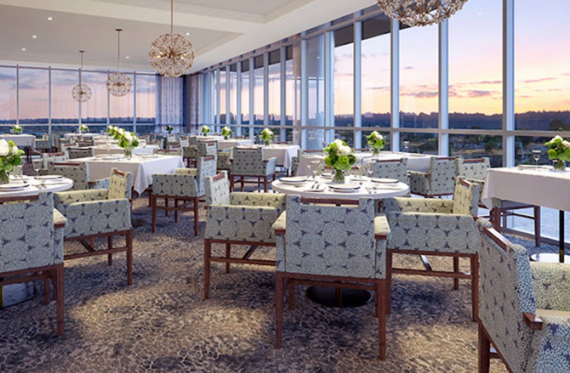 An elegant dining area with large windows offering a scenic view.