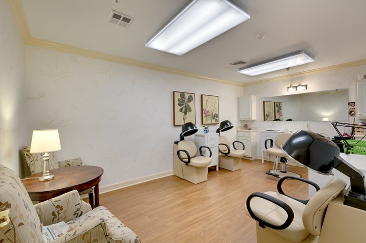 A well-lit salon interior with chairs and hair dryers neatly arranged.