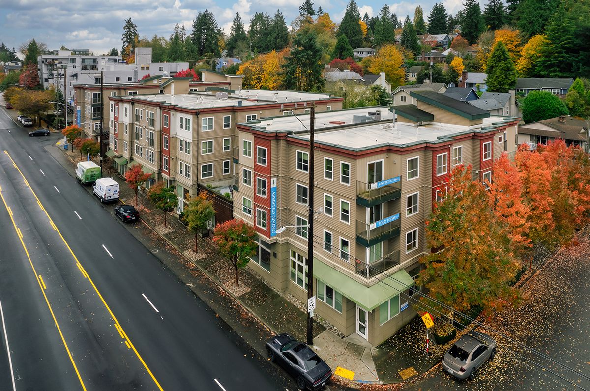 Aerial view of apartment buildings on a city street during autumn.