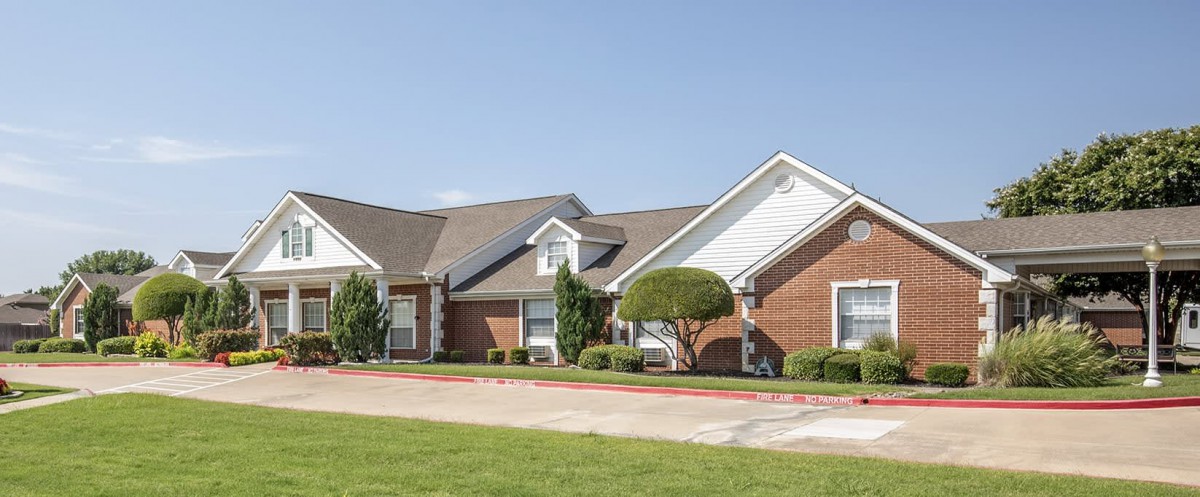 A suburban house with a well-maintained lawn and driveway.