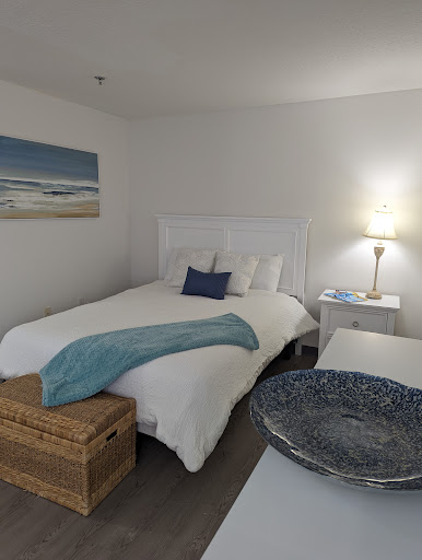 A cozy and inviting bedroom featuring a serene coastal theme with blue accents.