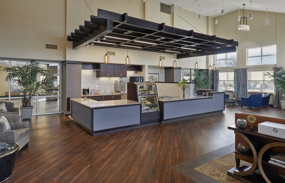 A modern cafe interior featuring a sleek counter and wooden flooring.