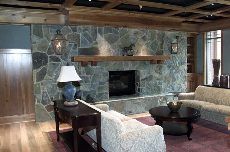 A cozy living room with a stone fireplace and modern decor.