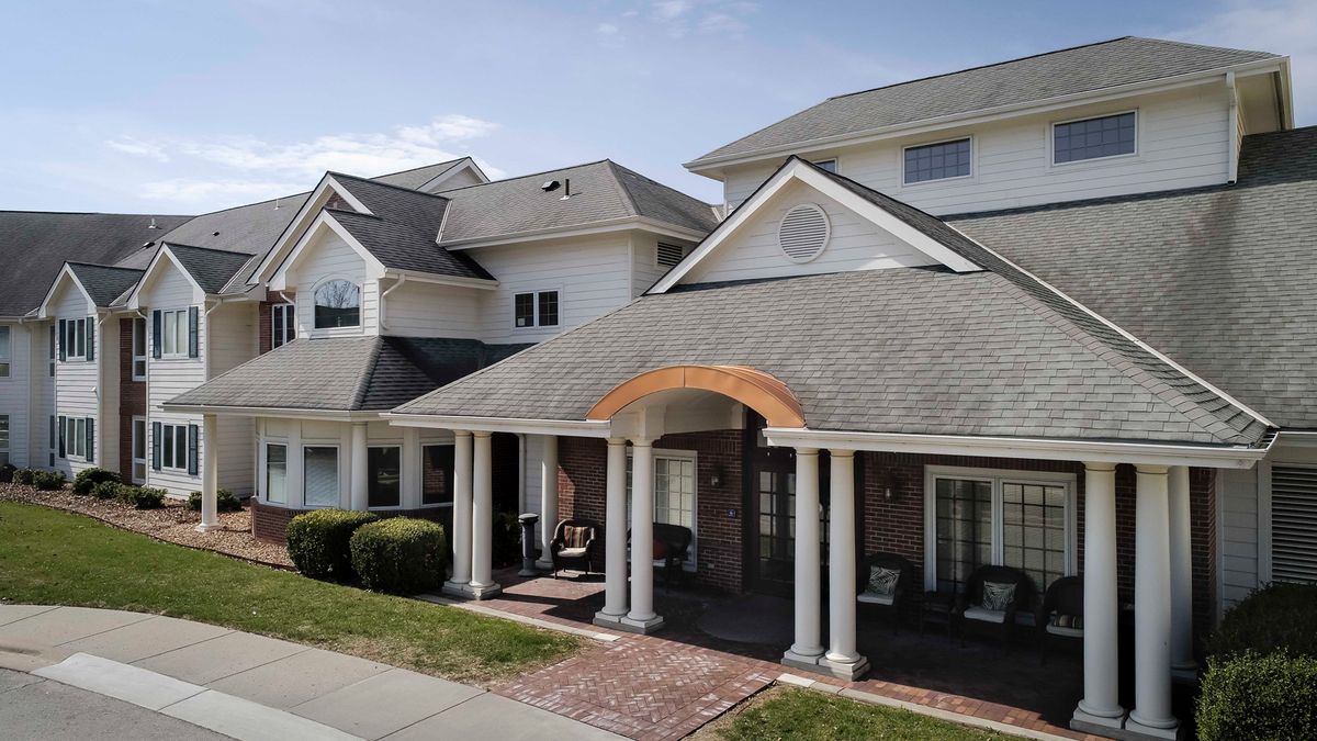 A large suburban house with a front porch and columns.