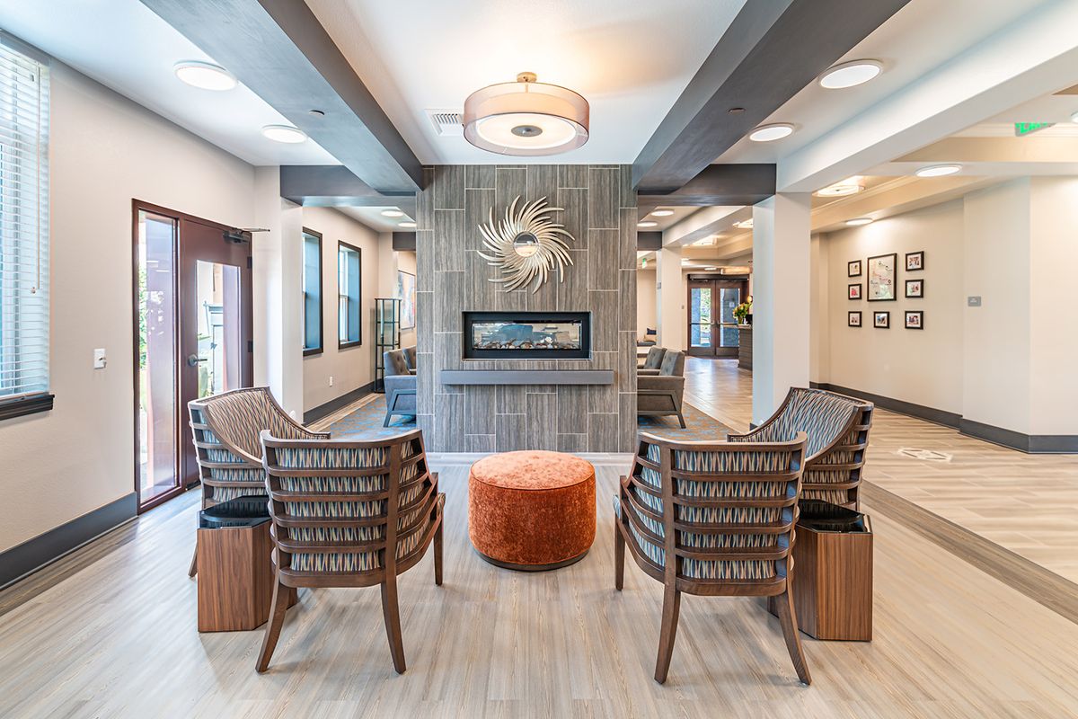 A modern living room with a central fireplace and comfortable seating arrangement.