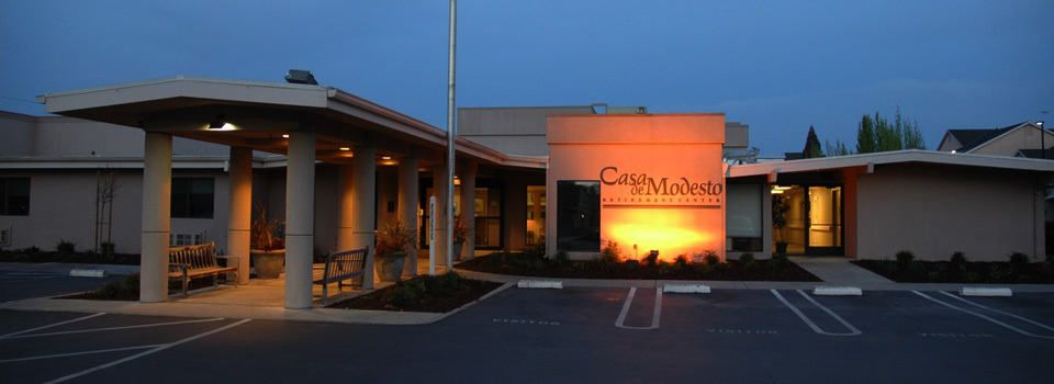 An illuminated building entrance at dusk.
