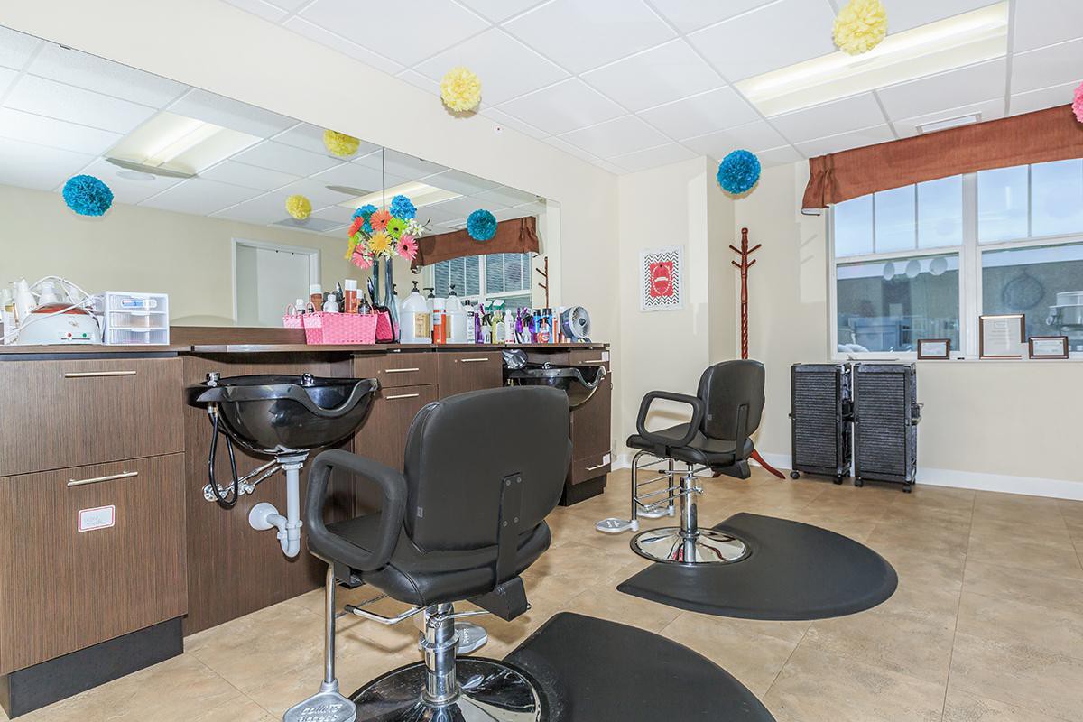 A well-equipped hair salon interior with styling chairs and colorful decorations.