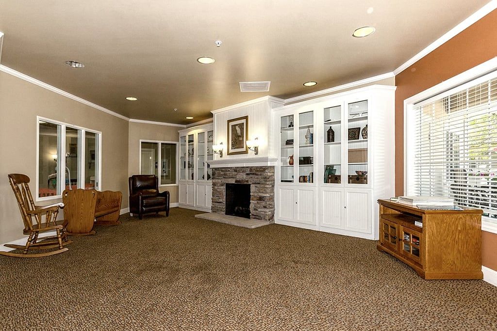 A spacious living room featuring a fireplace surrounded by built-in shelves and comfortable seating.