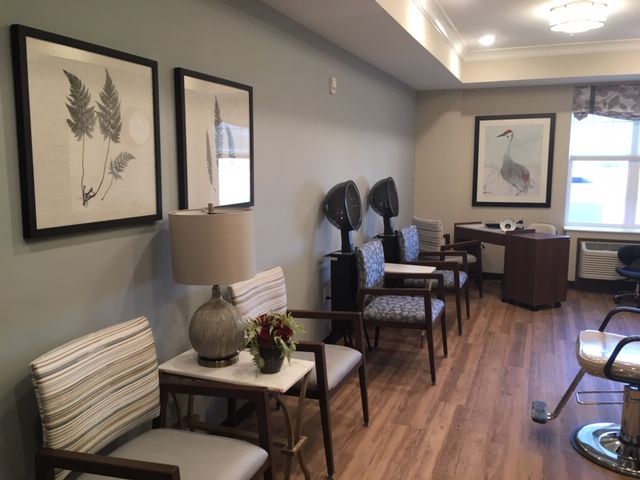 A modern waiting room with comfortable seating and tasteful artwork.