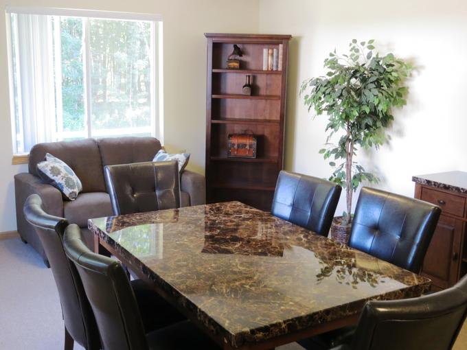 A cozy dining area with a marble table and comfortable seating.