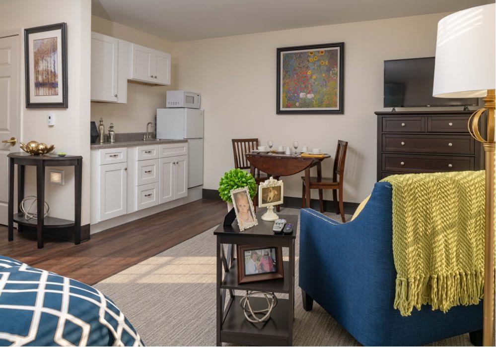A cozy apartment living area featuring a kitchenette, dining table, and comfortable seating.