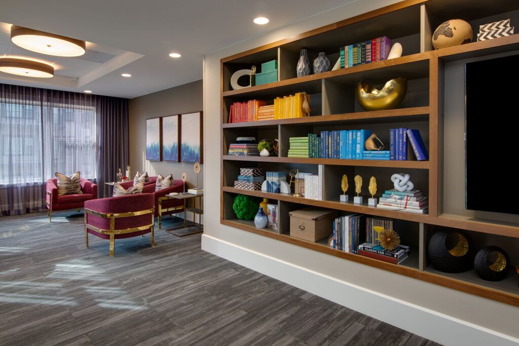 A modern living room featuring a colorful bookshelf with various decorative items.