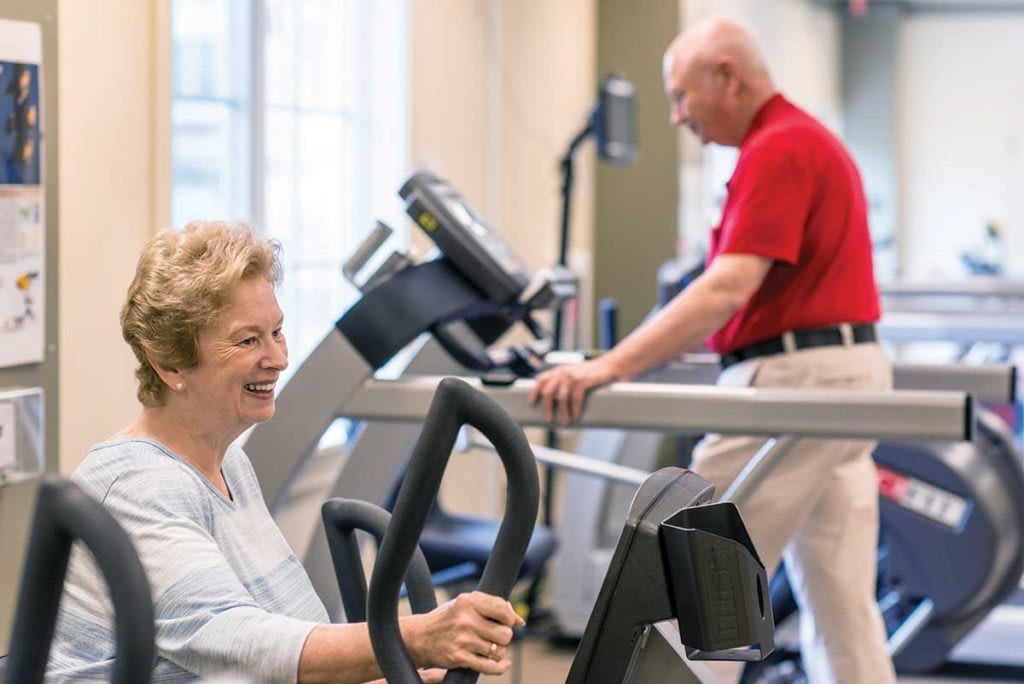 Seniors enjoying a workout session at the gym, focusing on fitness and health.