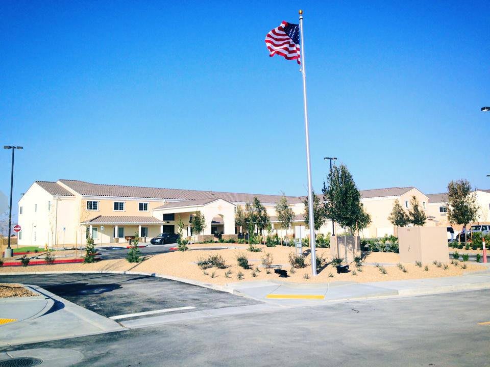 A building with an American flag flying on a clear, sunny day.