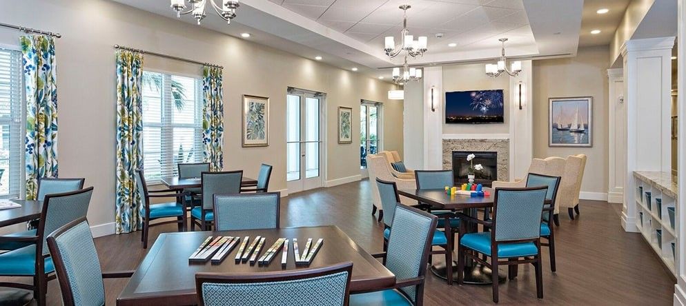 A comfortable and modern communal living space with tables, chairs, and decorative elements.