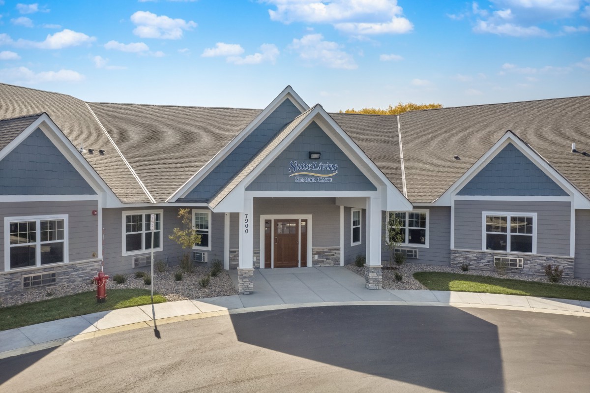 A suburban residential building with a peaked roof and a welcoming entrance.
