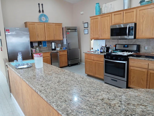 A well-equipped modern kitchen featuring granite countertops and stainless steel appliances.