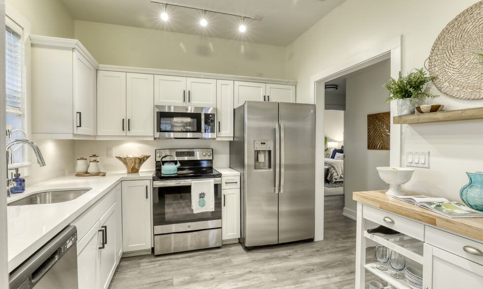 A modern kitchen with stainless steel appliances and white cabinets.